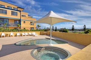 2 BR UNIT ACROSS THE ROAD FROM THE PRETTIEST SURF BEACH Picture 1